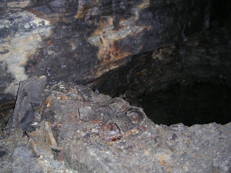 bh_clogs_westhighcrossvein.jpg - Somewhere along West High Cross Vein, we went past a deep blue water sump, Helen called us back and pointed out the old shoes by the edge. This was the first time we has seen any shoes down the mines.