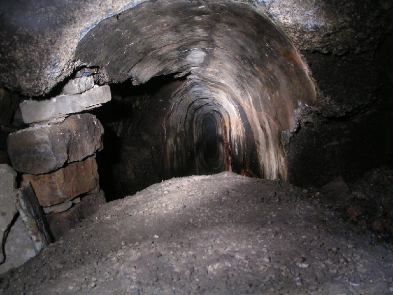 cch_spillwaystart1.jpg - This is the mine version of the 'Scream'. Just inside the main adit looking into the spillway over a section of concrete arching that has dropped from the roof.