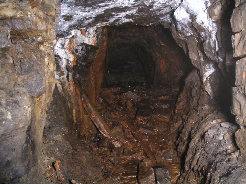 cc_sublevel_rise2ch.jpg - From the sublevel, this crosscut leads to the short rise into the Caplecleugh High Level. Care was needed whilst climbing this rise as some of the arching is unsupported.
