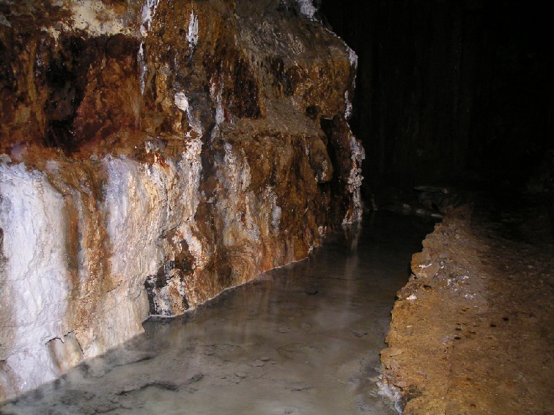 lowflatetc.JPG - Just past the shaft is a pool with calcite crusts in and flowing into it.