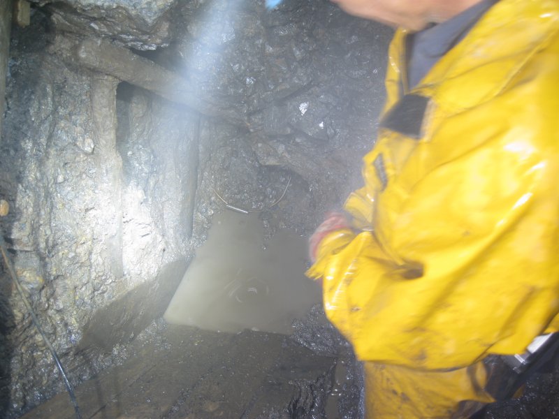 Img_3854.jpg - Shaft bottom, wet and steamy. Some of the old timbers can be seen.