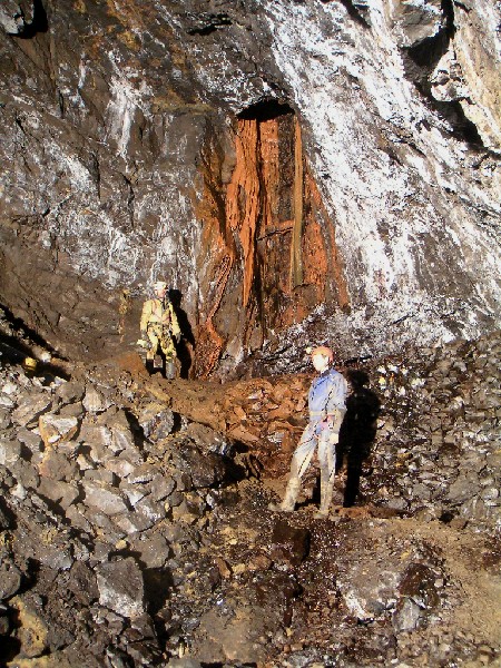 ghg_stope_shaftcalciteflow2.jpg - The large shaft with its calcite flow. Jim is standing in front of one of the walls that has been built across the stope. Lit up with flash powder.