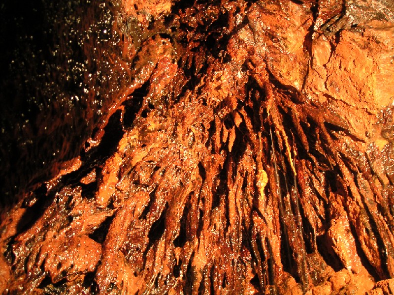 ghgl_orcheformations3.jpg - Ochre formations in the choked area of the passage.