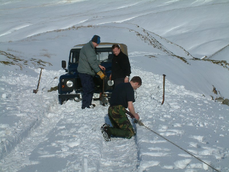 snowtrip_36.jpg - With some old SRT rope anchored to the bridge, we winched away with no joy. Back to the digging.