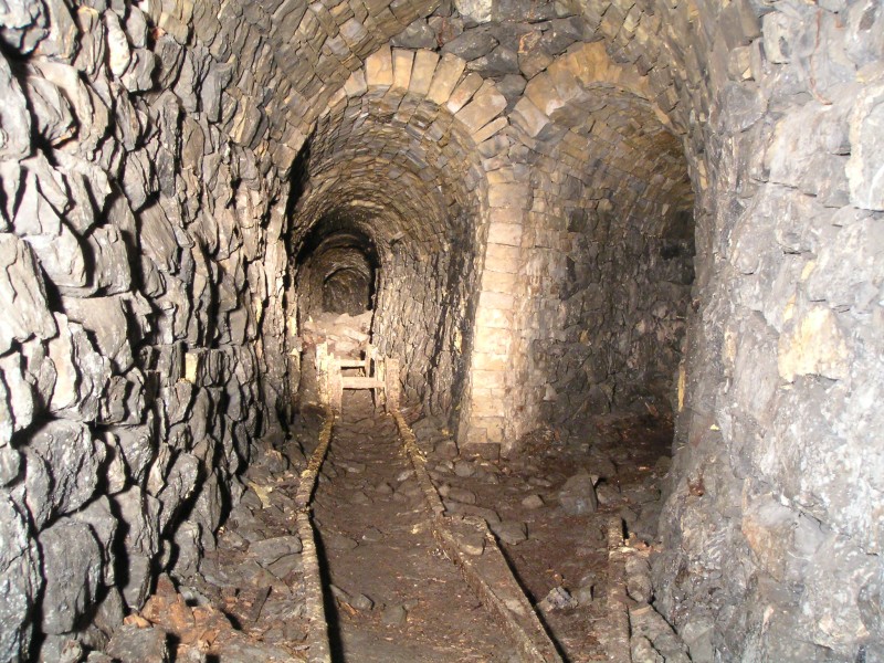 sc_oldfan_sublevel_wheels1.jpg - Further into the sublevel, we came in from past the wheels, as can be seen the passage way is in good condition despite some collapses. Here you can also see part of a set of points.