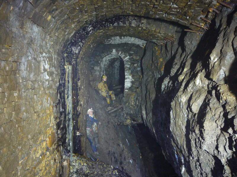 sc05_risetop_east1.jpg - Looking east from the rise, the level continues, however the floor here has dropped out. This an interesting cross section and reminder what you are often walking on. The dark secondary mineralisation is the bottom of the very high stone lined shaft.
