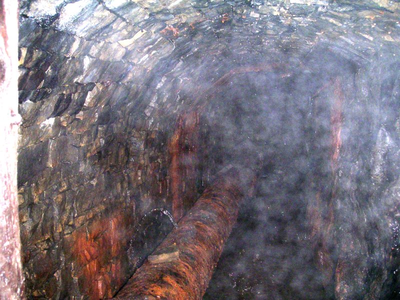 sc_middlecleughlevel_pastboggshaft3.jpg - The passage going the other way, the pipe is full of water - but no one wanted a drink.
