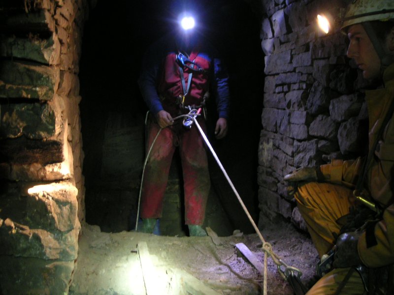 sc_sublevelcrossvein2.jpg - If you go down the passage from which the picture was taken in the junction picture you come to a drop in the floor which goes down into a large chamber shown in the next picture. This looks like something out of a close encounter of the mine kind. Charlie about to go down and karli kindly providing illumination for the shot.