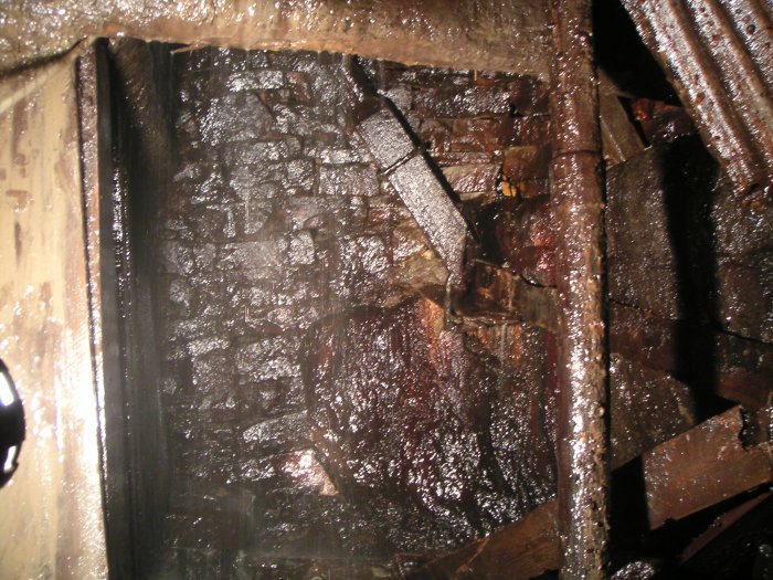 pickerings_rise3.jpg - The first drop of Pickering's Rise, goes to a short sublevel some 36m long. The drop is about 3m. Pickering's Rise then continues down to the Caplecleugh Horse Level. The rise is some 23m long. Note the square ventilation trunking remains.