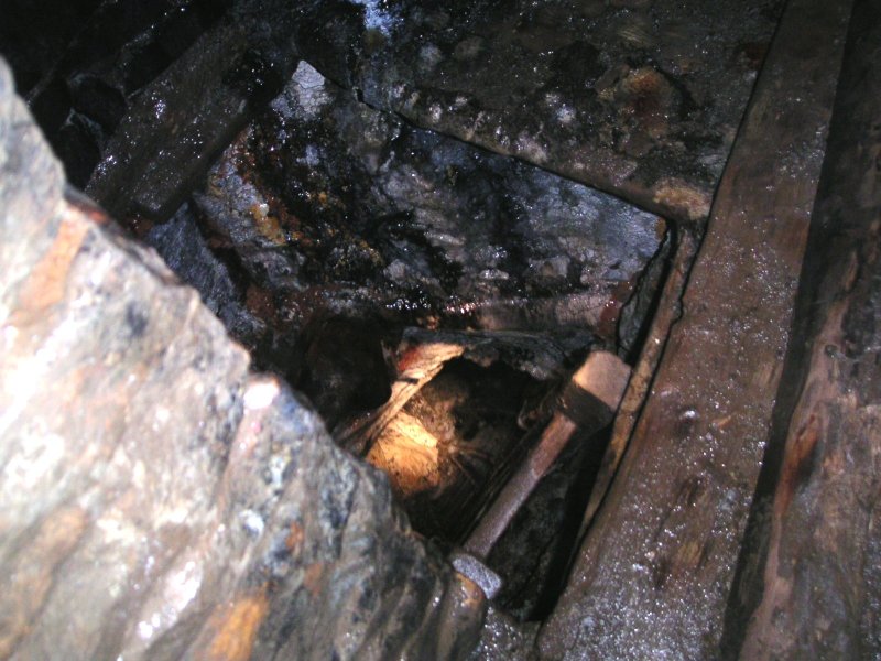 Pict0024.jpg - Having been down the second set of ladders we realised that the first set we by-passed (these) where the ones which drop the 30m or so down to Capelcleugh Level in one go on the other side of the blocked part that we had just been down. These are the calcified ladders that many explores know.