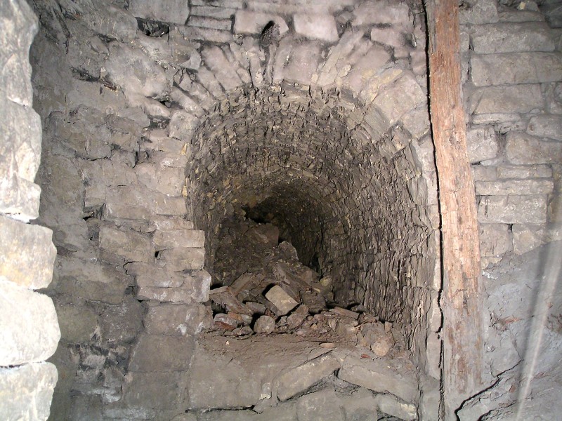 sc_letterboxsump_level_se.jpg - The first sublevel looking southeast. There is a collapse in the foreground and a complete one after it, this is the level that we think may link in with a sump from the Smallcleugh Horse Level. Note all the dry rot hanging from the roof.