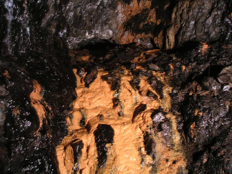 brownleyh_gbxvein_gudhorselevel_junction1.jpg - This is the junction with Guddamgill Horse Level. Above this mash of mud and calcified rocks is a shaft which leads to the Coal Sill Level. If you look carefully you can see the arch of the horse level. It is possible to walk round and bypass this.